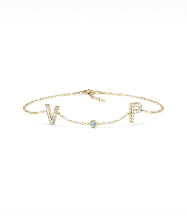 Custom initials solitaire bracelet in 14K yellow gold with aquamarine gemstone