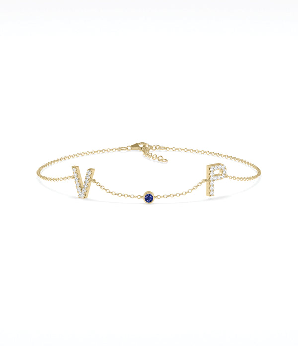Custom initials solitaire bracelet in 14K yellow gold with blue sapphire alternate view