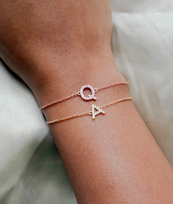 Model wearing diamond initial cable link bracelet in yellow and rose gold alternate view