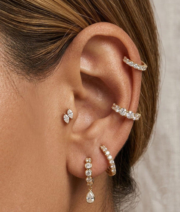 Model wearing pear lab diamond drop earrings styled with other earrings alternate view