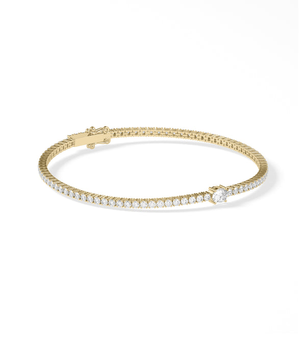 Solitaire center diamond tennis bracelet in yellow gold side profile view alternate view