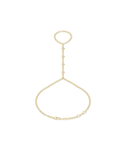 14k yellow gold hand chain with bezel-set diamonds connecting a finger ring to a wrist bracelet