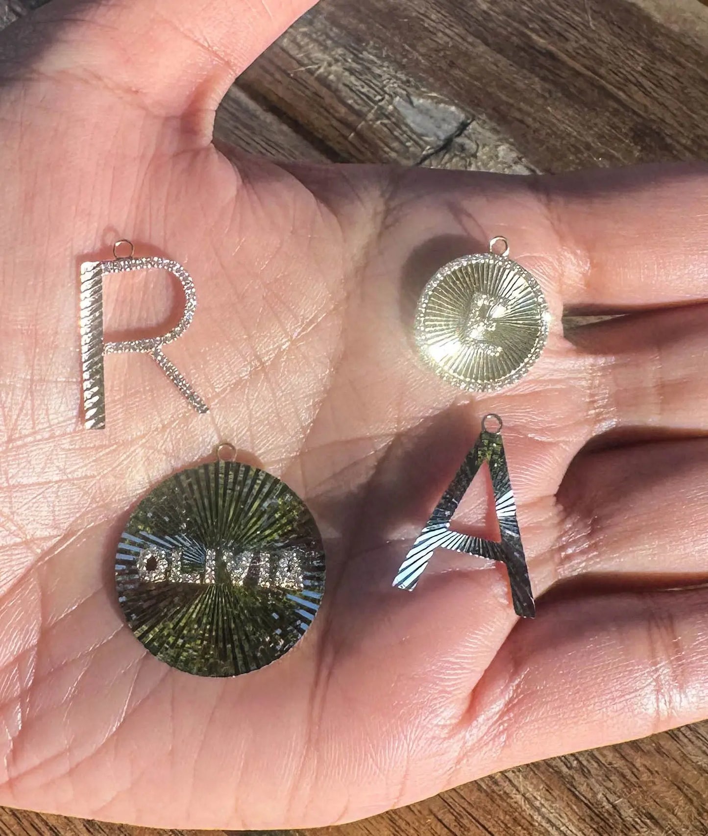 Fluted name charm displayed on elegant jewelry presentation showing proportions