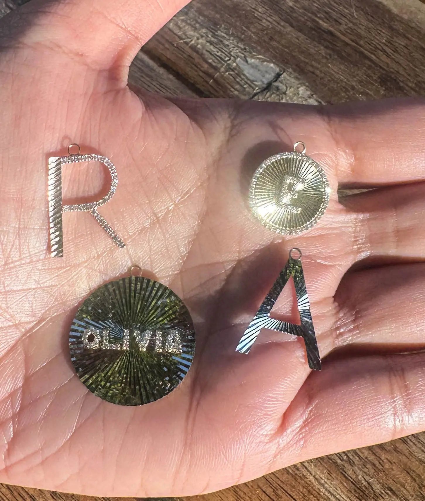 Fluted name charm displayed on elegant jewelry presentation showing proportions