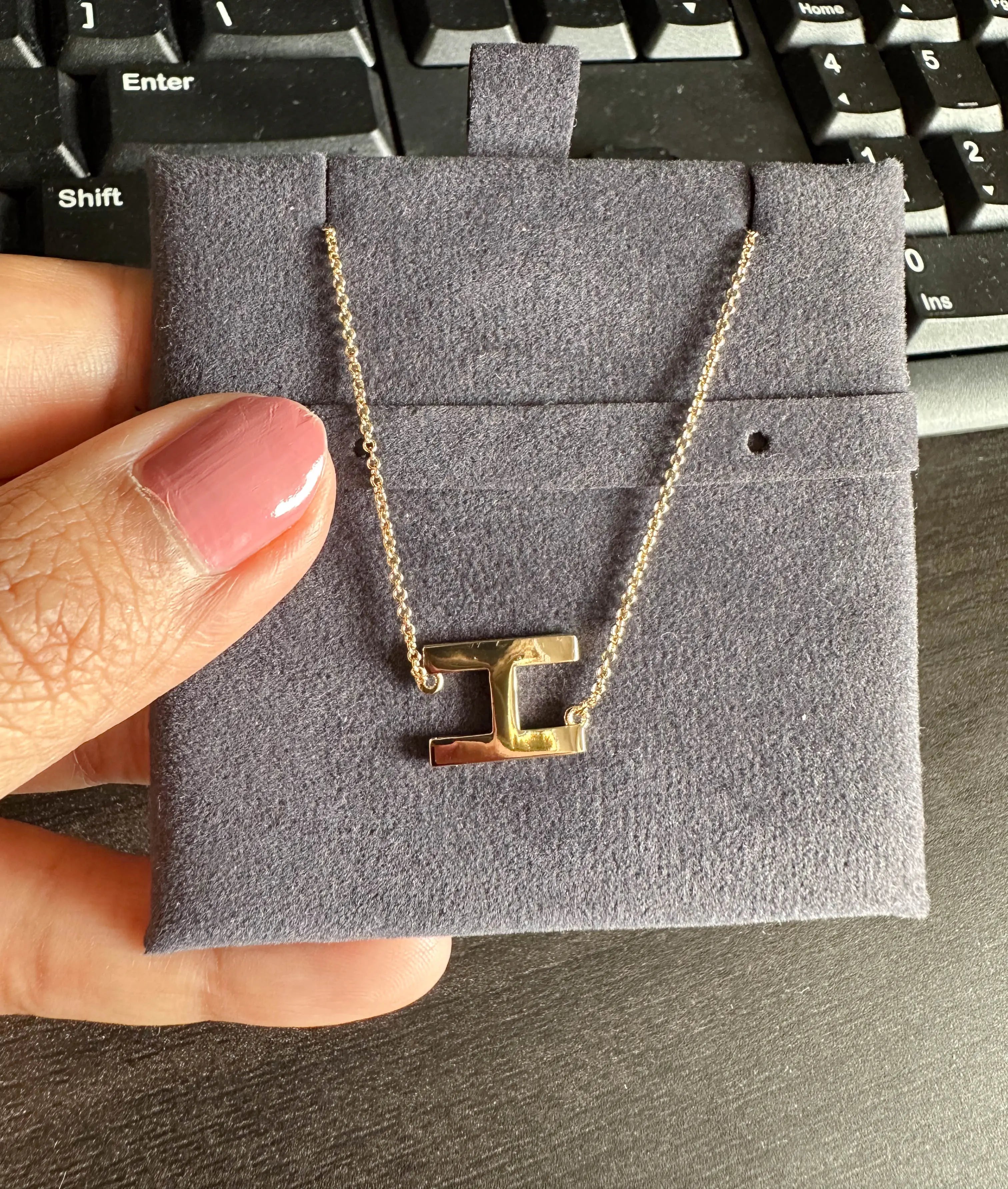 Closeup of Gold Horizontal Initial Necklace showing engraved initial detail on bar