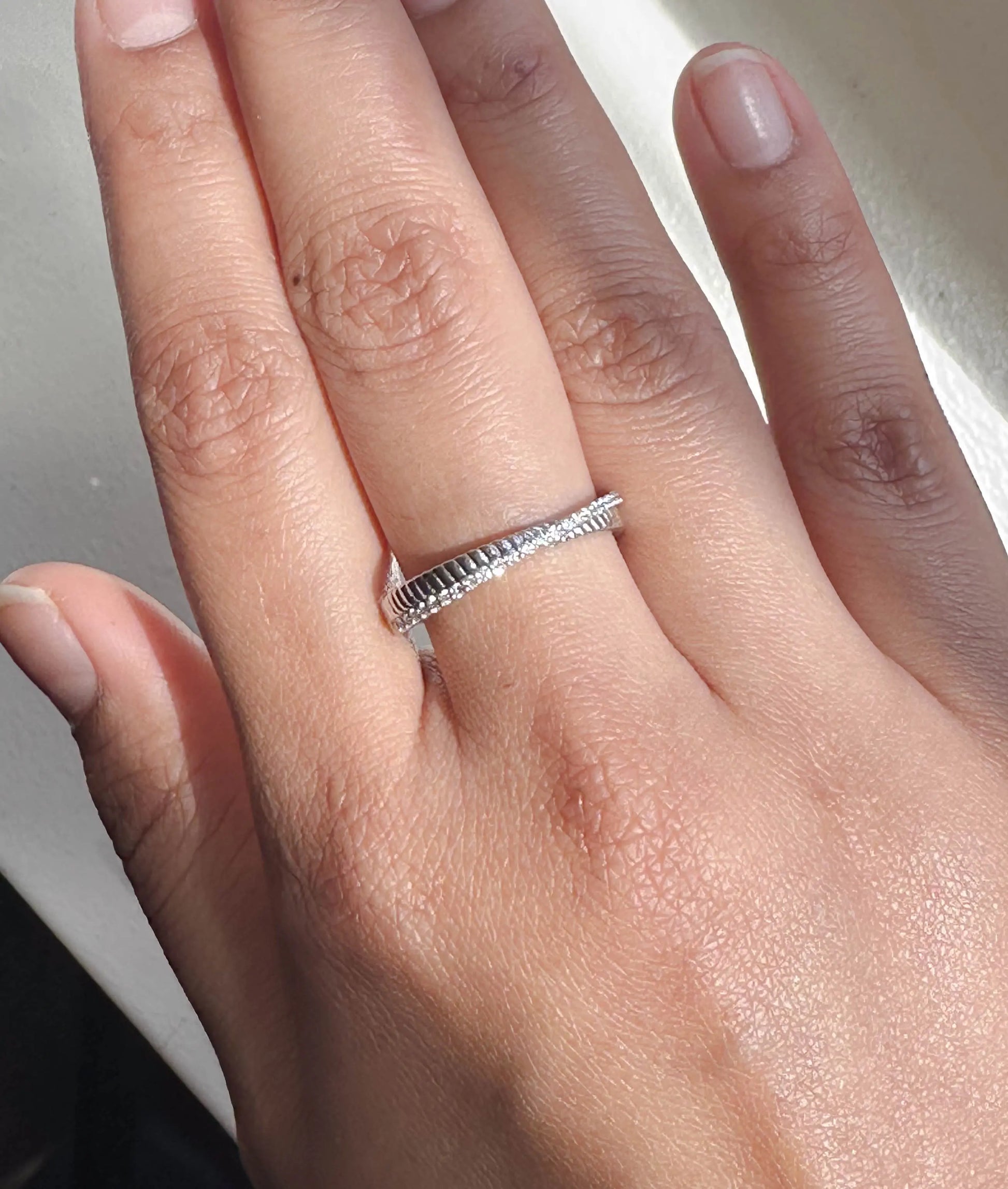 Closeup of Diamond Line and Fluted Gold Band Ring showing diamond line and fluted texture detail