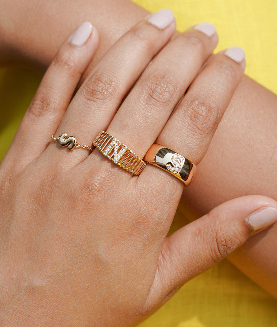 Custom Diamond Initial Band Ring on hand displaying statement wide band styling
