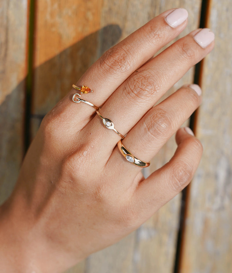 Solitaire Bypass Initial Ring on hand displaying dual-element design