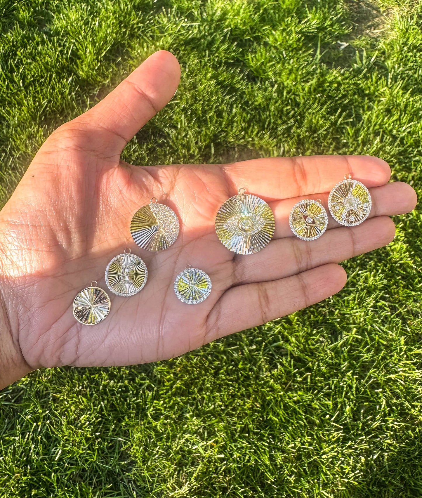 Fluted half moon charm displayed on elegant jewelry presentation with chain