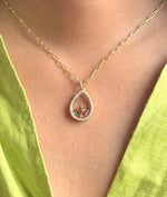 Diamond pear shape glass locket charm styled as luxury layered necklace piece