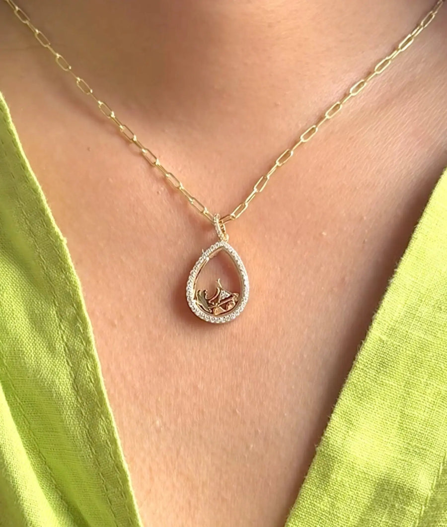Diamond pear shape glass locket charm styled as luxury layered necklace piece