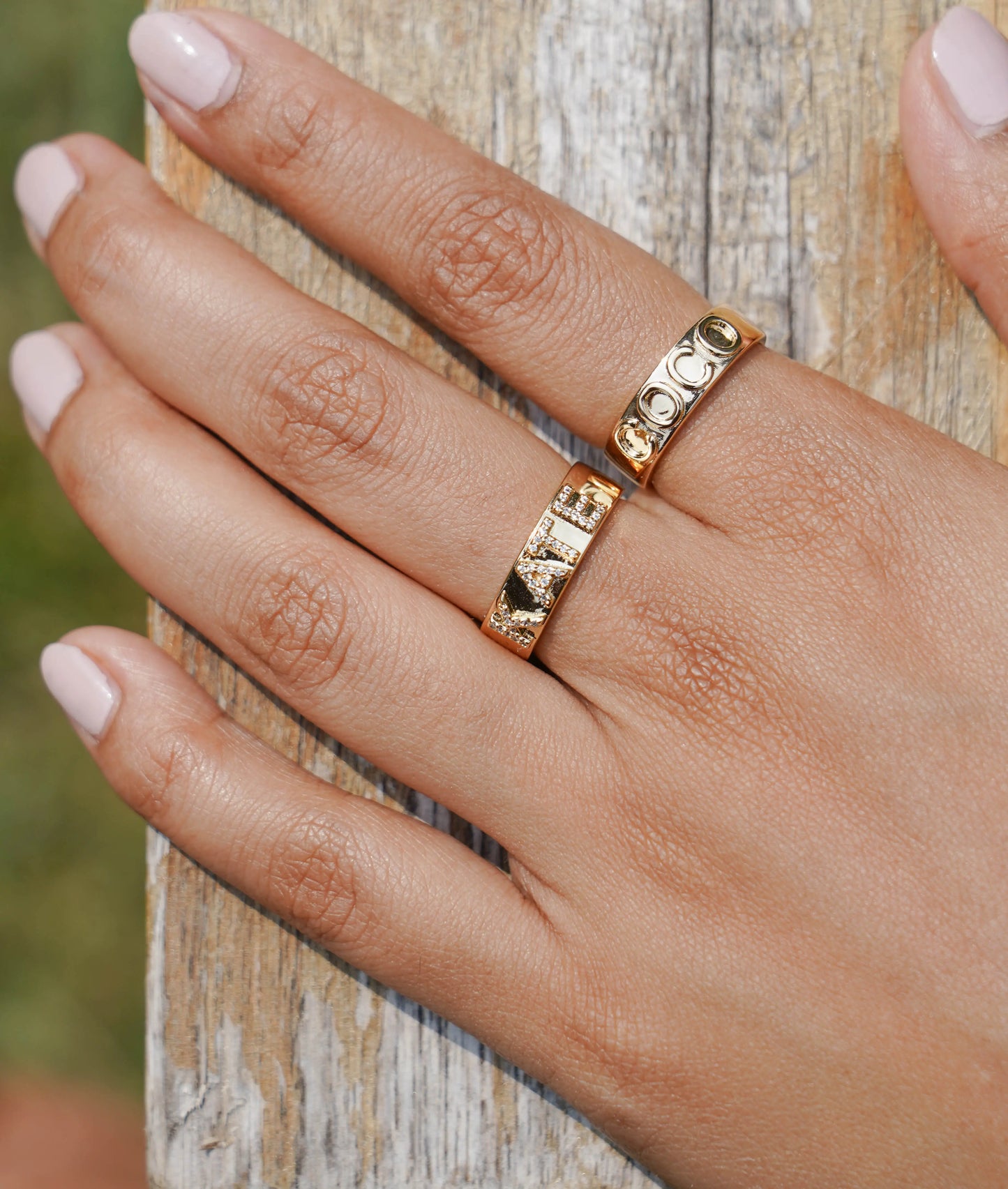 Custom gold name ring showing smooth surface and engraving space detail
