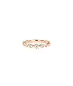 Detail of 5 Stone Bezel Set Graduating Diamond Band Ring showing graduated sizing and gold finish