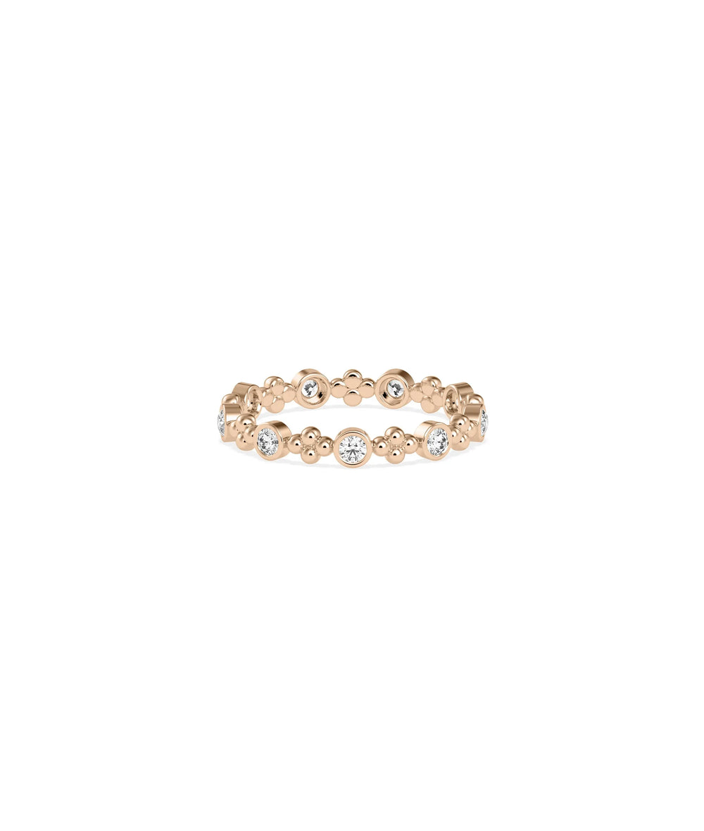 Rose gold eternity ring featuring diamond stations and decorative bead detailing