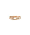 Rose gold chevron ring featuring bezel-set diamond stations and modern pattern