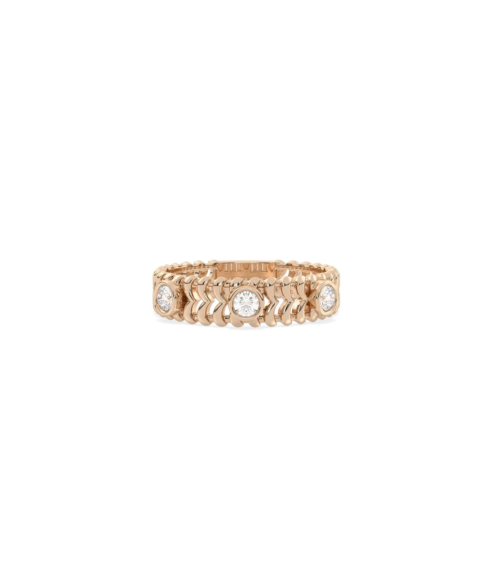 Rose gold chevron ring featuring bezel-set diamond stations and modern pattern