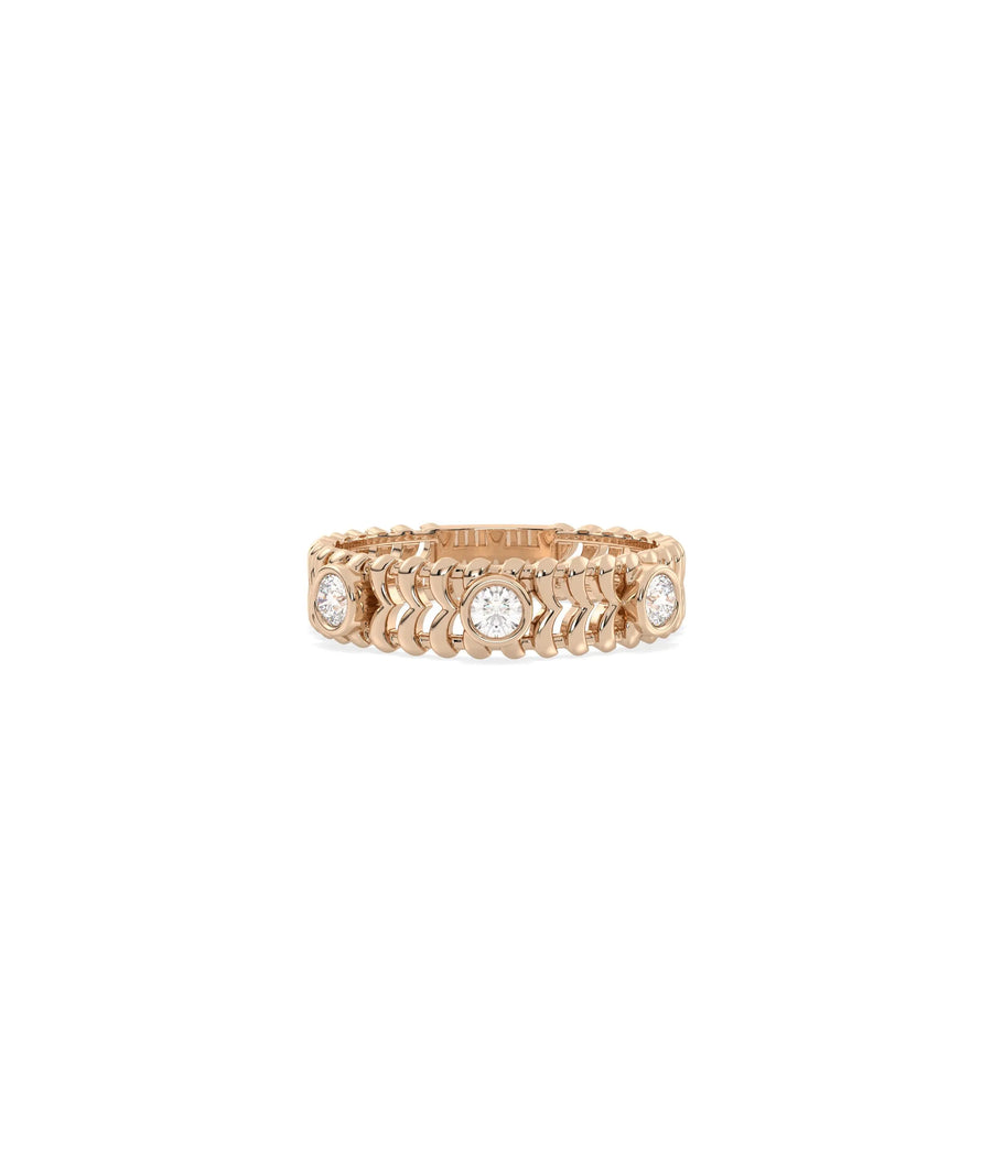 Rose gold chevron ring featuring bezel-set diamond stations and modern pattern