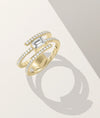Swirl solitaire ring side profile displaying flowing band design with diamonds