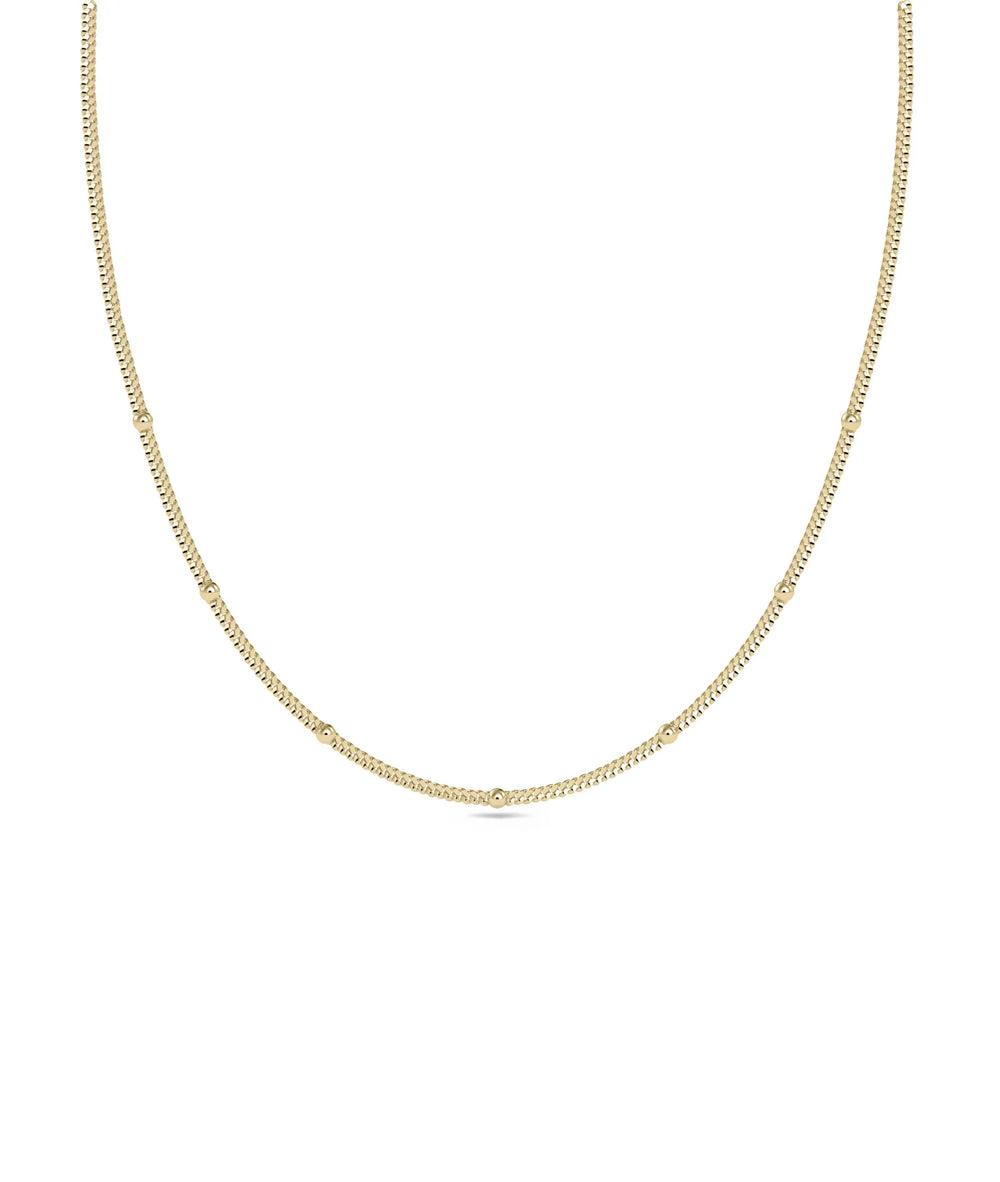 Gold Bead Station Necklace in yellow gold with delicate bead accents along chain