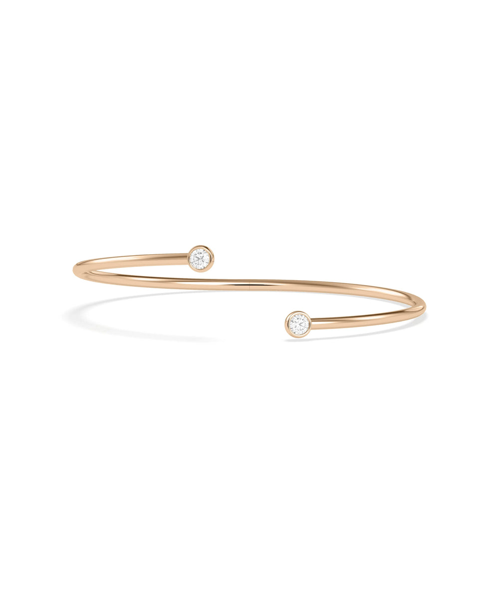 Gold flex bangle two bezel diamonds profile angle showing adjustable construction design