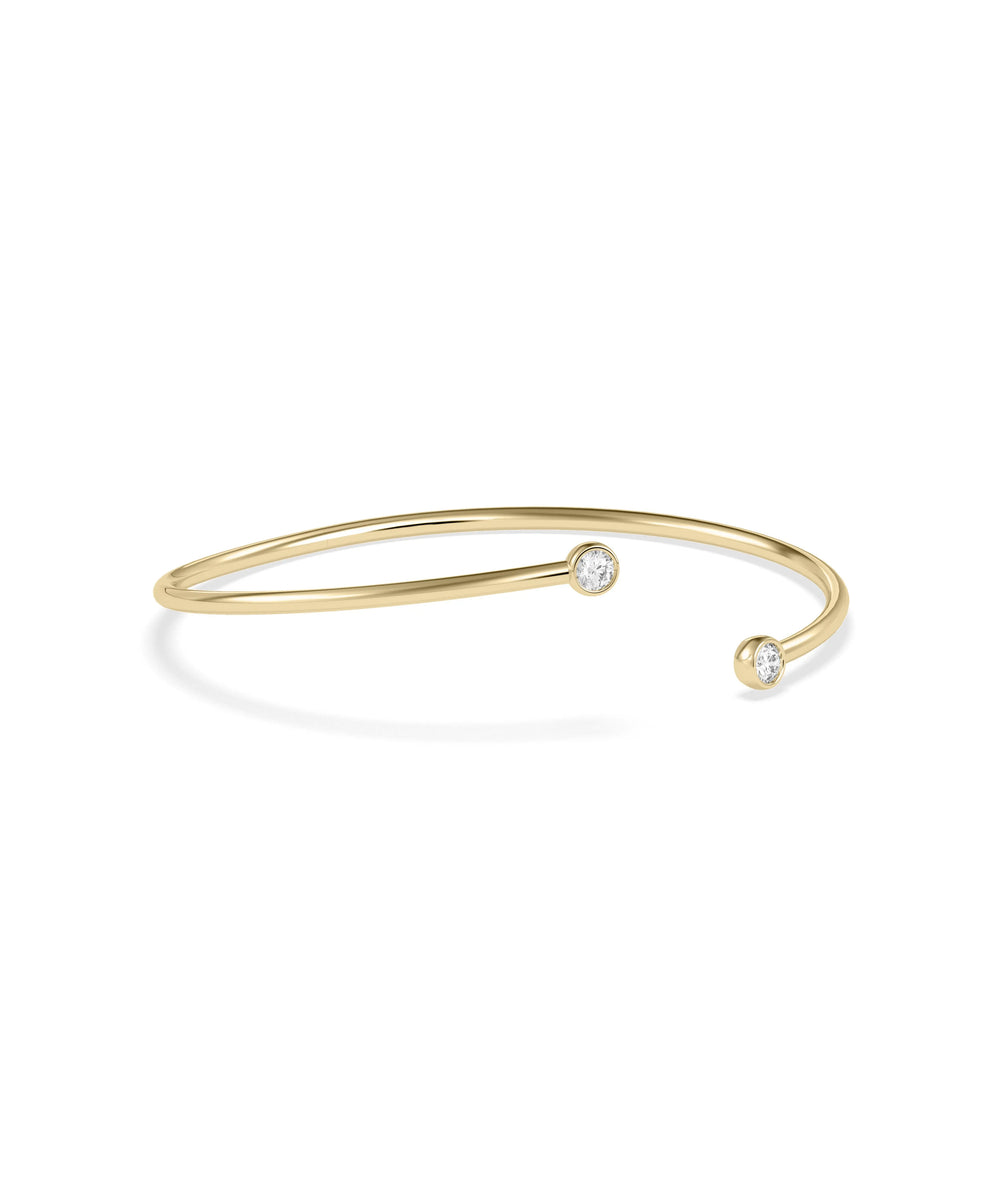 Two stone diamond bangle bezel set solid gold flex construction closeup detail view