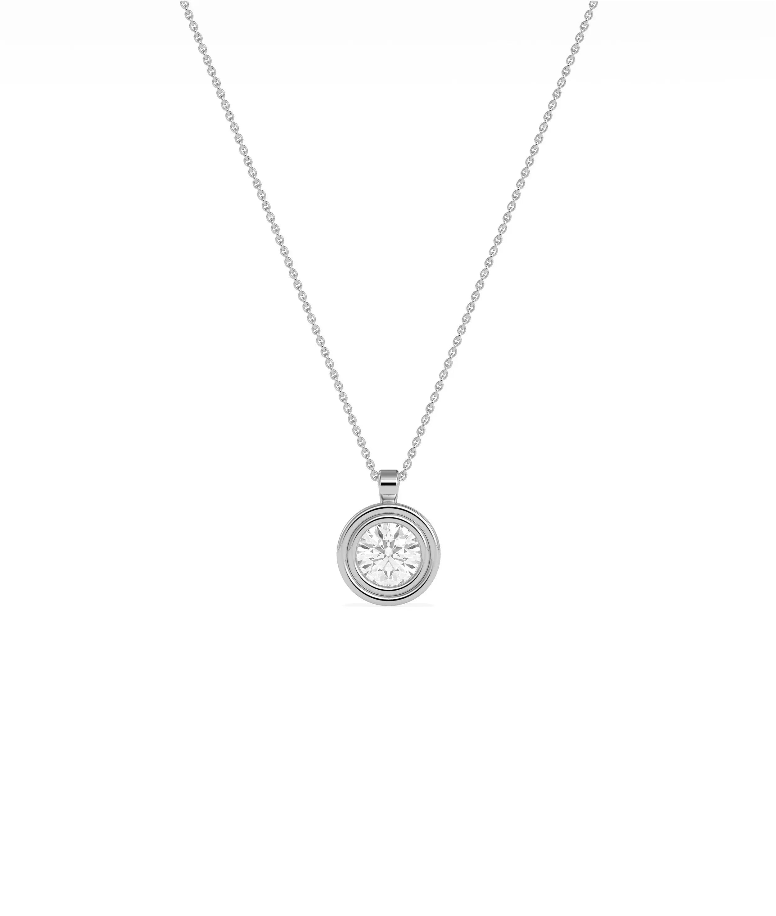 Gold double bezel diamond charm flat lay showing attachment loop and craftsmanship detail