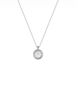 Gold double bezel diamond charm flat lay showing attachment loop and craftsmanship detail