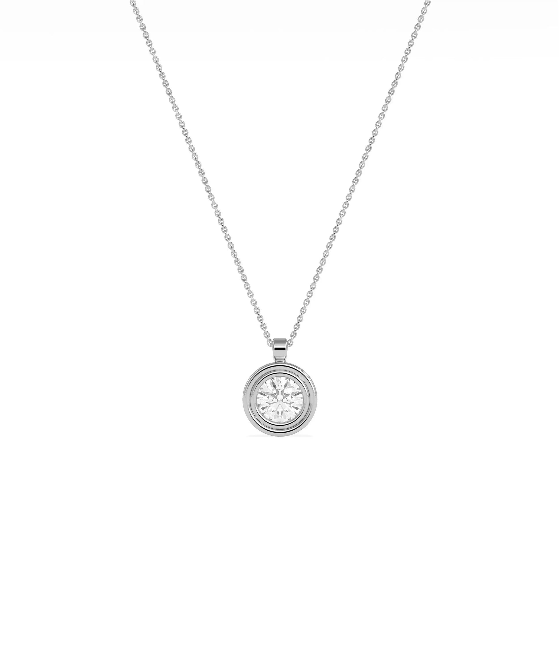 Gold double bezel diamond charm flat lay showing attachment loop and craftsmanship detail