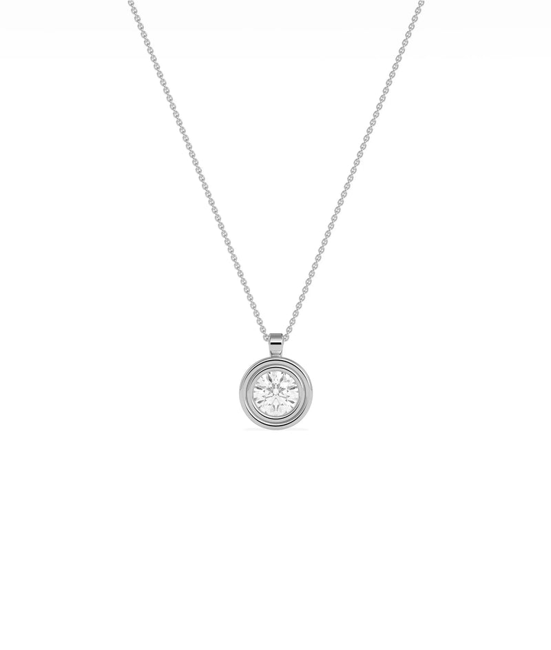 Gold double bezel diamond charm flat lay showing attachment loop and craftsmanship detail