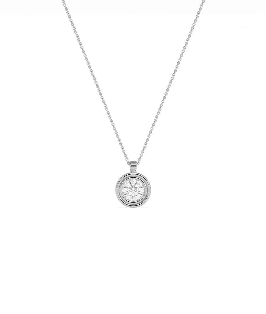 Gold double bezel diamond charm flat lay showing attachment loop and craftsmanship detail