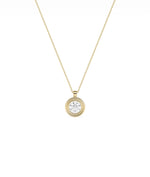 Layered bezel diamond charm solid gold concentric design closeup showing dimensional depth