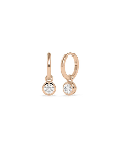 Diamond dangle earrings bezel set design solid gold protective settings closeup detail