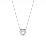 Heart shaped diamond necklace in bubble bezel setting solid gold chain closeup view