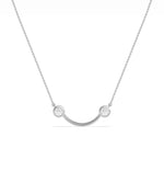 Smile pendant necklace showing curved design with two diamond accents
