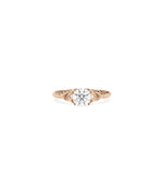 Round diamond ring with filigree design close up of scrollwork patterns