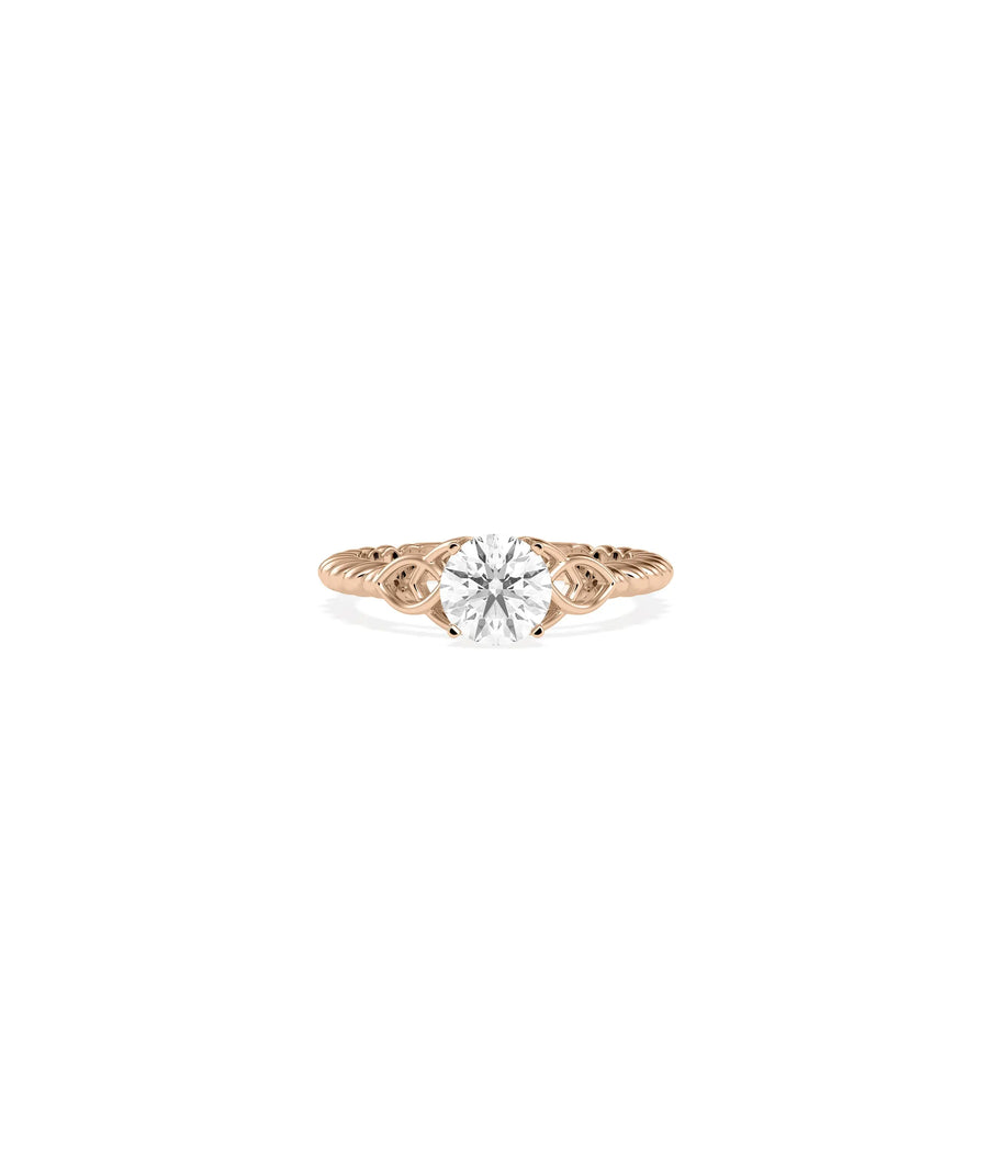 Round diamond ring with filigree design close up of scrollwork patterns