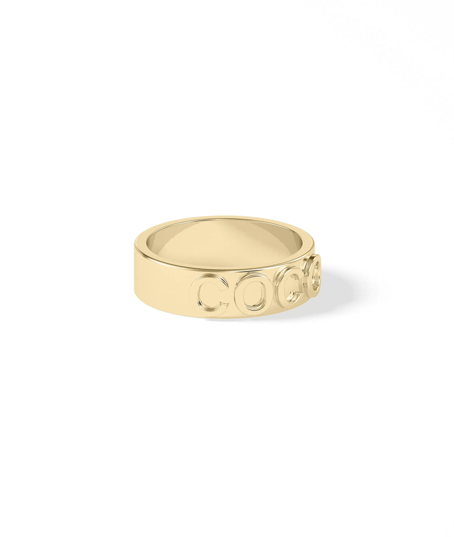 Personalized solid gold band ring close up of name inscription clarity