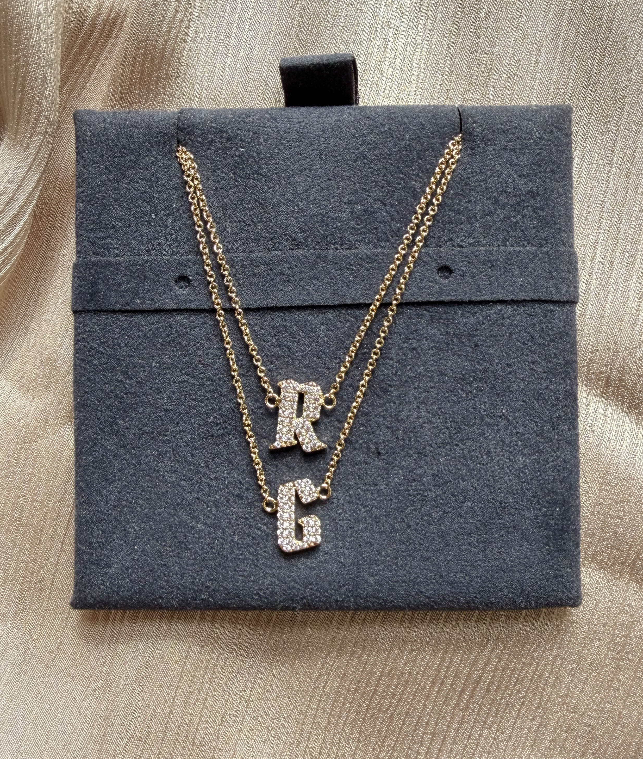 Pave initials layered 11mm diamonds close-up