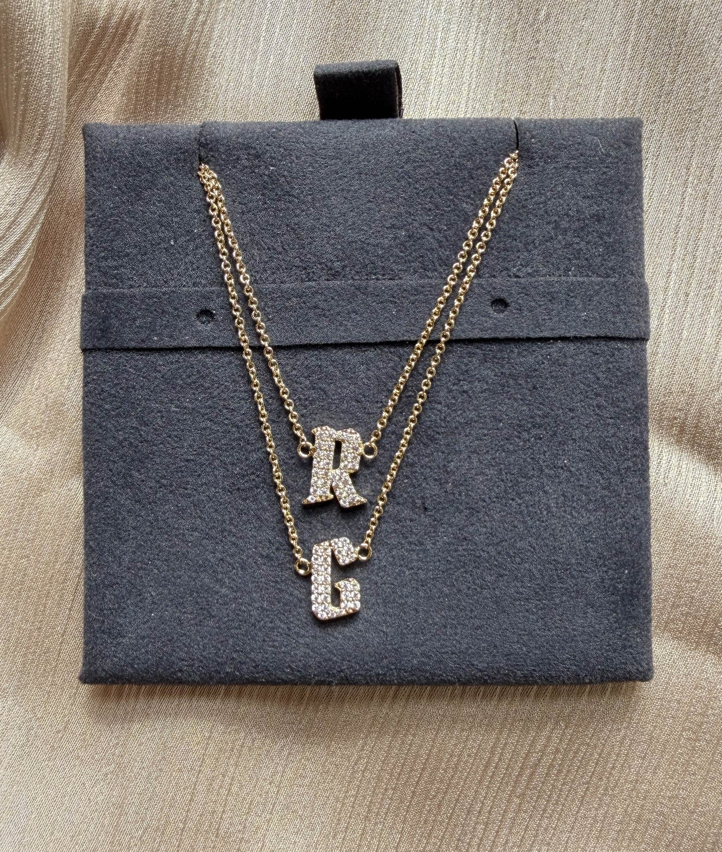 Pave initials layered 11mm diamonds close-up