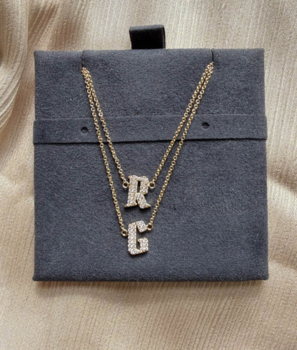 Pave initials layered 11mm diamonds close-up