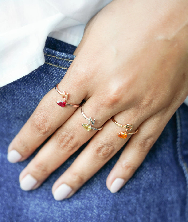 Close-up of Solitaire Bypass Initial Ring showing bypass crossing detail