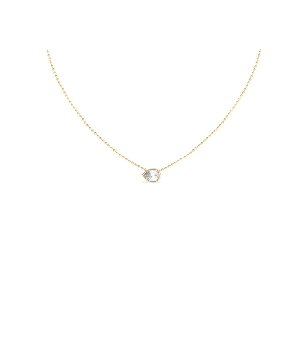 Bezel set pear lab diamond solitaire necklace on a delicate yellow gold ball chain