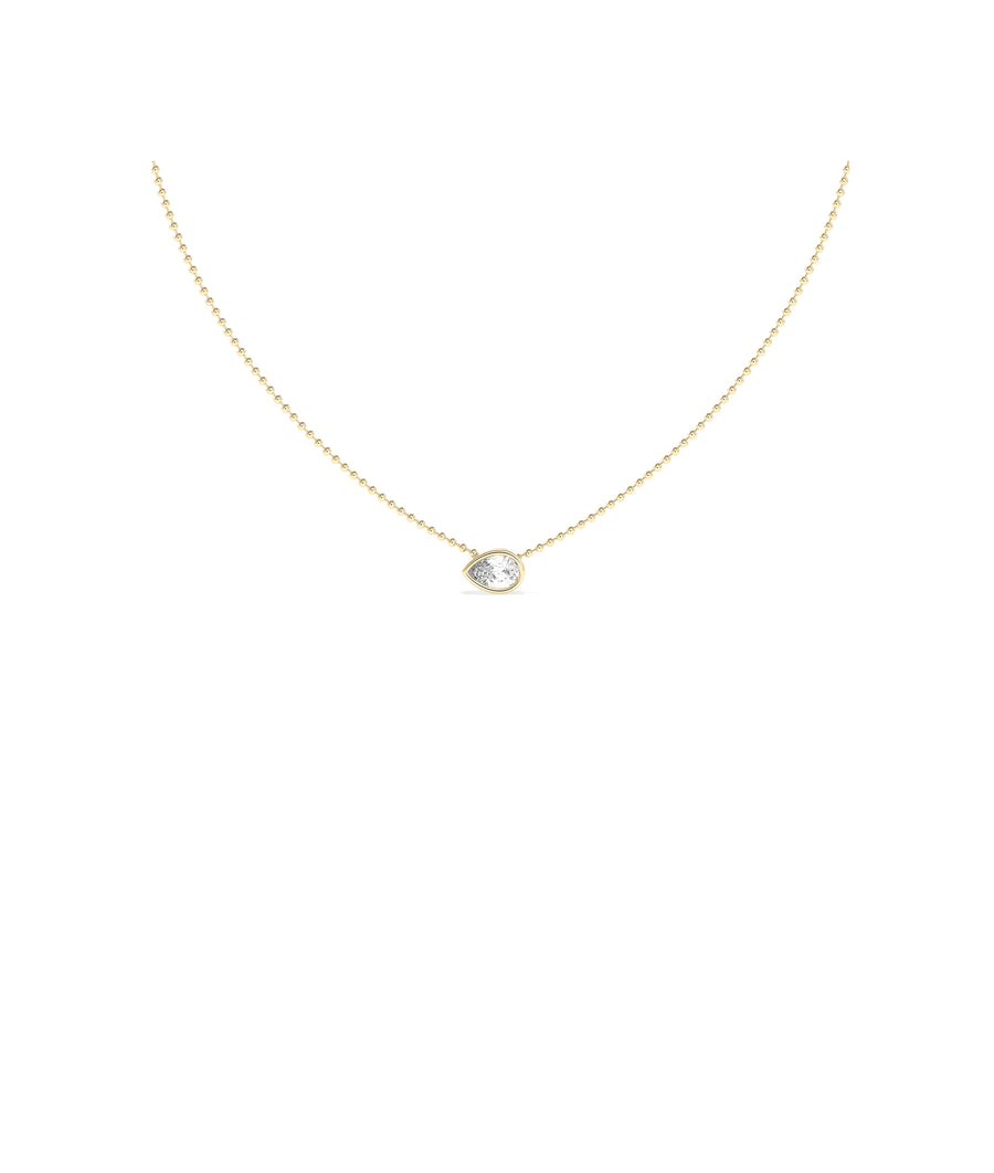 Bezel set pear lab diamond solitaire necklace on a delicate yellow gold ball chain