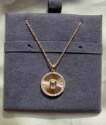 Diamond outline fluted circle solitaire pendant necklace in yellow gold