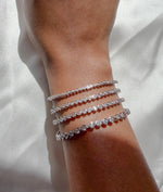 Model wearing bezel diamond tennis bracelet in 14K solid white gold