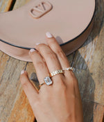 Bezel set emerald lab diamond solitaire ring in 14K yellow gold on model