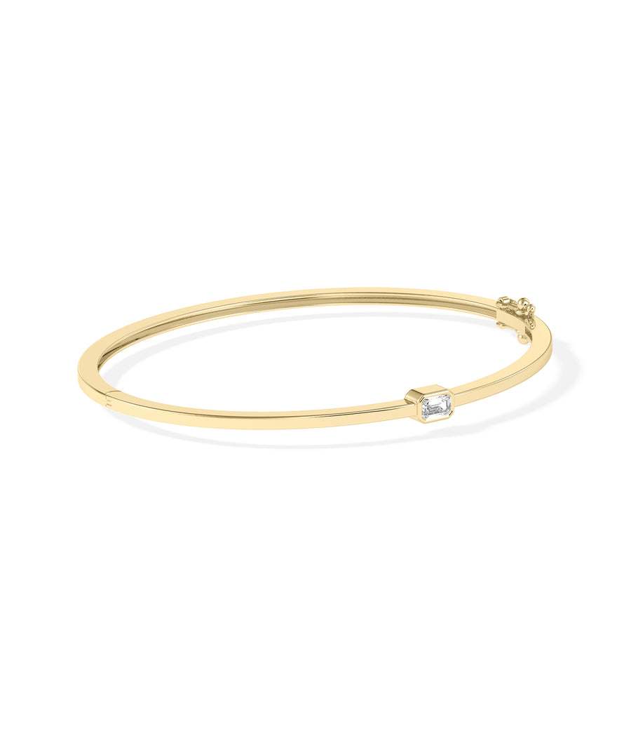 Bezel-set solitaire diamond bangle in 14K yellow gold side view