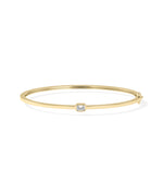 Bezel-set solitaire diamond bangle in 14K yellow gold