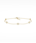 Bezel set station bracelet in 14K yellow gold with diamond gemstones