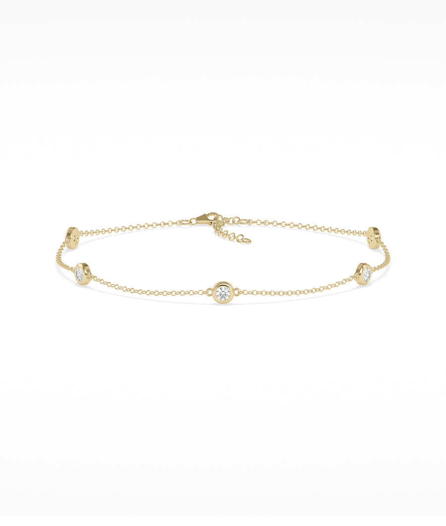 Bezel set station bracelet in 14K yellow gold with diamond gemstones